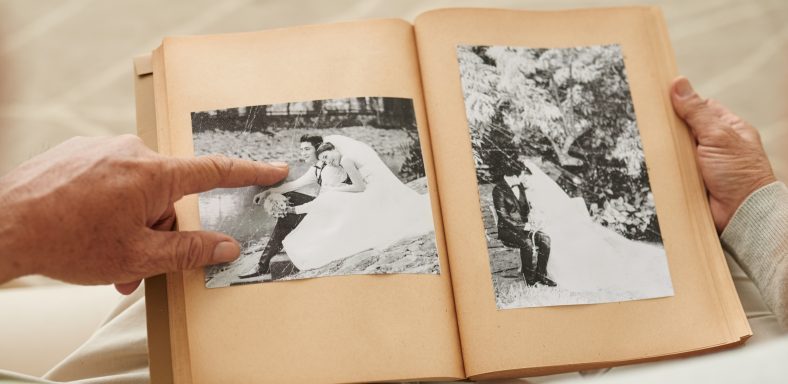 Senior couple looking at their wedding photos in photo album
